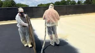 spray2.jpg Roofing crew in protective coveralls | commercial roof coating application