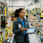 Warehouse staff reviewing inventory with tablet