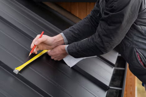 roof-inspect.jpg Roofer taking measurements on sloped shingle roof