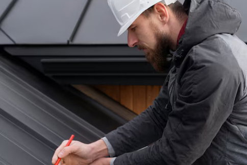 roof-inspect.jpg Roofer taking measurements on sloped shingle roof