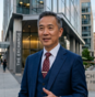 Businessman in suit standing outdoors near office buildings