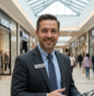 Businessman with tablet in retail/mall setting